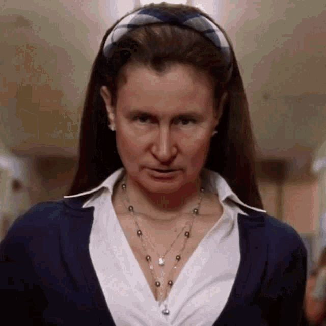 a woman wearing a plaid headband and a necklace