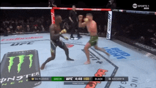 two men fighting in a boxing ring with a monster energy drink in the background