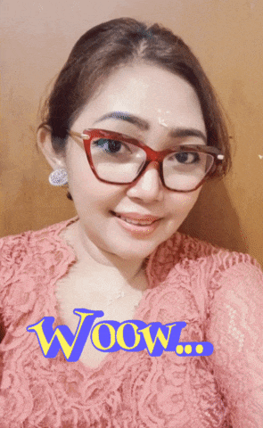 a woman wearing glasses and a pink lace top with the word wow on the bottom