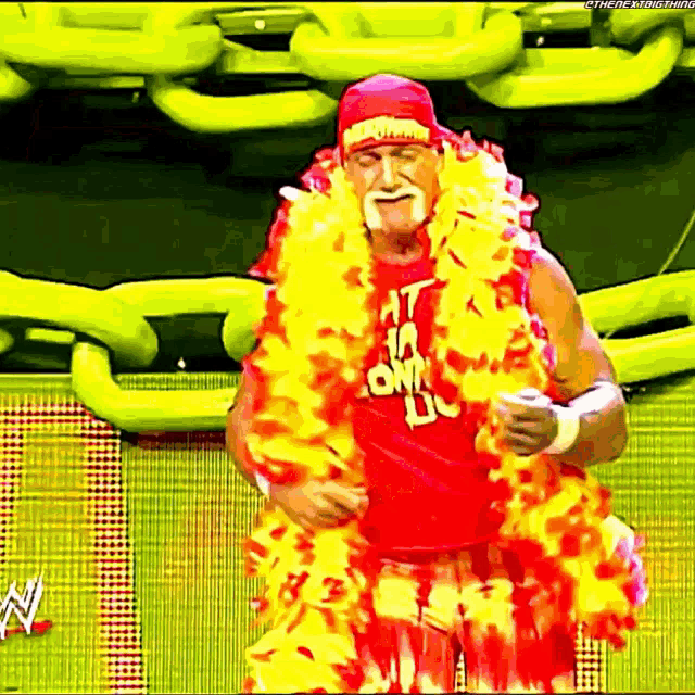 a man wearing a red shirt that says hulk hogan is dancing