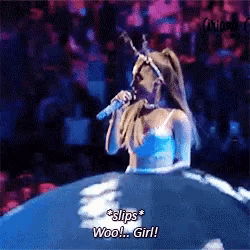 a woman in a blue dress is singing into a microphone and says " slips woo girl ! "