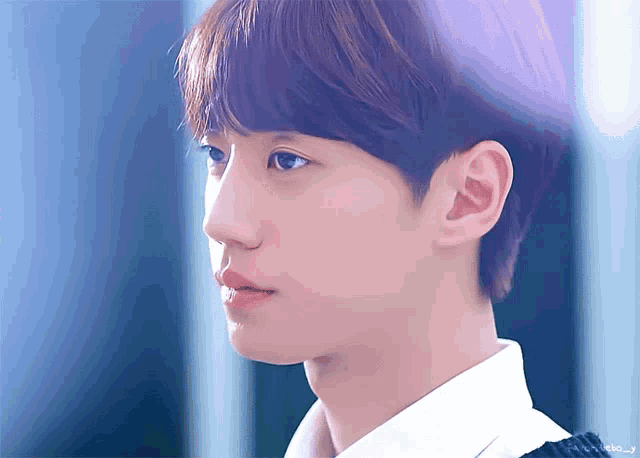 a close up of a young man 's face with the word j on the bottom left