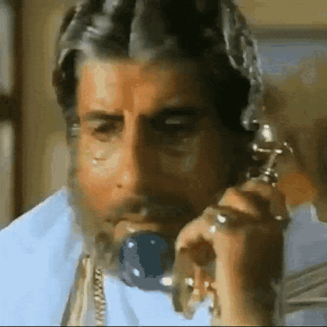 a man with a beard talking on a phone