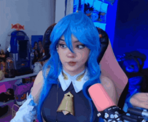 a woman with blue hair is sitting in a chair