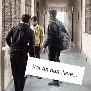 three men are standing in a hallway with a sign that says " koi aa naa jaye "