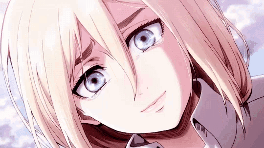 a close up of a girl with blonde hair and blue eyes looking at the camera .
