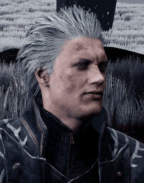 a man with gray hair is wearing a black jacket and a black shirt