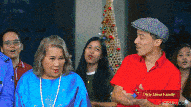 a group of people are standing in front of a dirty linen family christmas tree