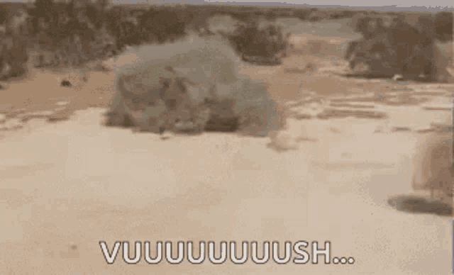 a person is riding a dirt bike in the desert with the words vuuuuuush written on the bottom .