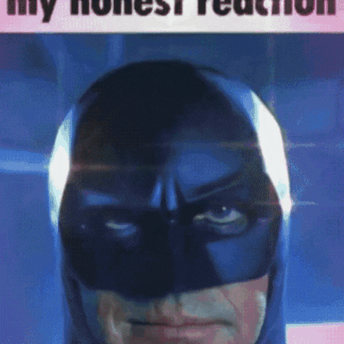 a close up of a man wearing a batman mask with the words " my honest reaction " on the bottom
