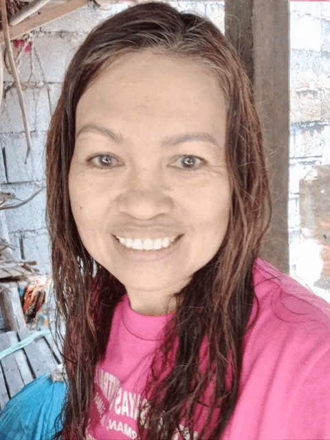 a woman wearing a pink shirt that says ' day ' on it