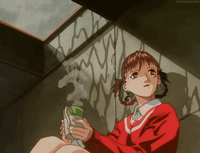 a girl in a red sweater is holding a cell phone in her hands