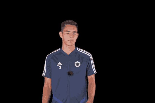 a man wearing an adidas shirt with the number 3 on the front