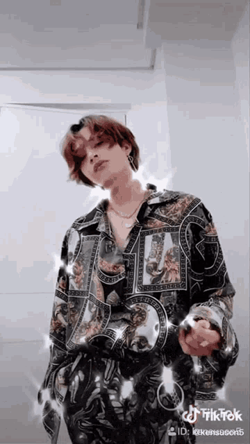a man wearing a shirt that says ' tik tok ' on it