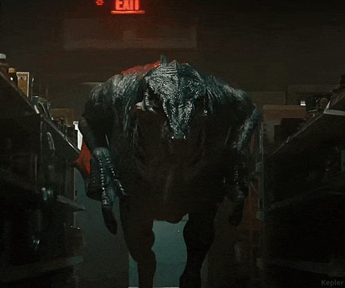 a dinosaur is laying on top of a shelf with popcorn