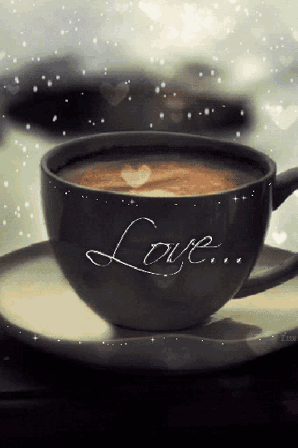a cup of coffee on a saucer that says love