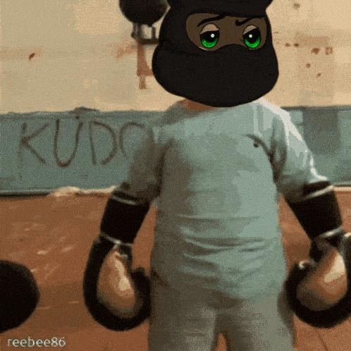 a person wearing boxing gloves is standing in front of a wall that has the word kudo written on it