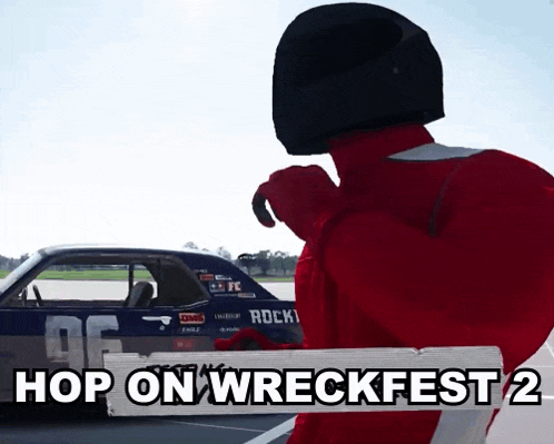 a man wearing a helmet stands in front of a car that says hop on wreckfest 2 on it