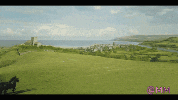 a picture of a field with a castle in the background and the words @mm on the bottom right