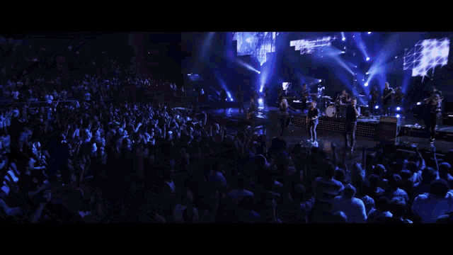 a man plays drums in front of a crowd