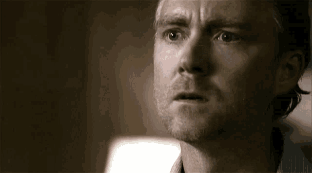 a close up of a man 's face with a third eye visible .