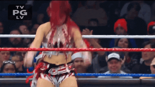 a woman is in a wrestling ring with a tv pg lv logo above her