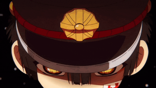 a close up of a person wearing a hat with a badge on it