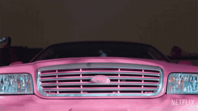 a pink ford car is parked in a garage with netflix written on the side