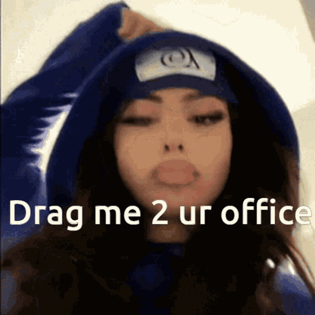 a girl wearing a blue hoodie and a beanie says drag me 2 ur office