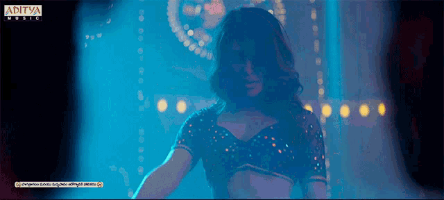 an ad for aditya music shows a woman in a crop top