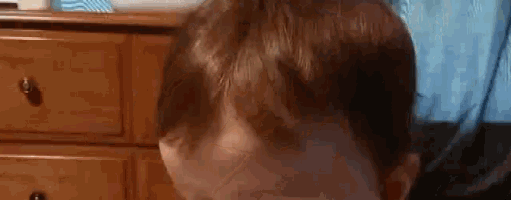 a close up of a person 's head with a cat behind them .