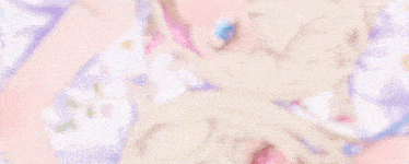 two anime girls are laying next to each other on a blanket .