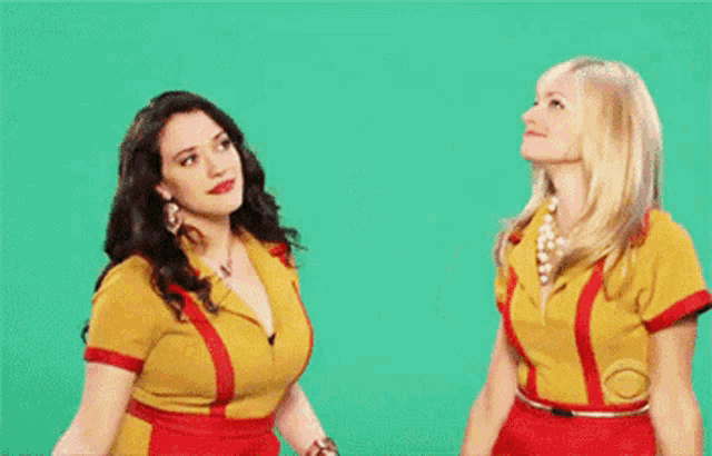 two women are standing next to each other on a blue background .