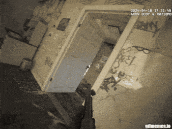 a room with graffiti on the walls and a door that says axon body 4 x0710mb