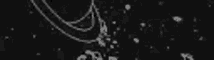 a black and white image of water splashing on a black surface .