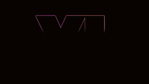 a purple letter vi is lit up in a dark room