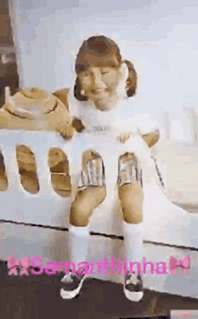 a little girl is sitting on the wing of an airplane with the name samantha written on the bottom