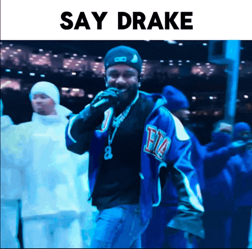a man in a blue jacket is singing into a microphone with the words say drake below him