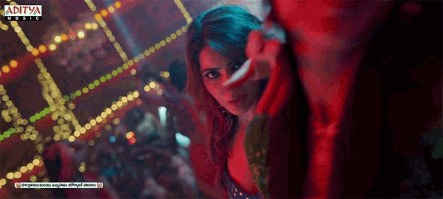 an ad for aditya music features a woman dancing