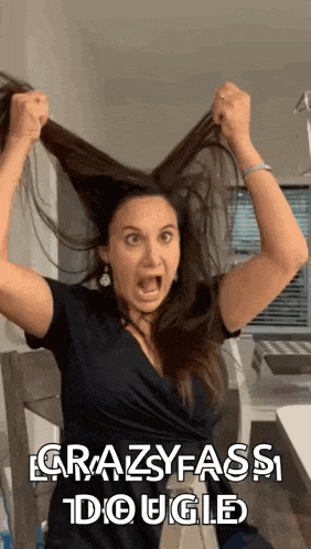 a woman is holding her hair in her hands and screaming .