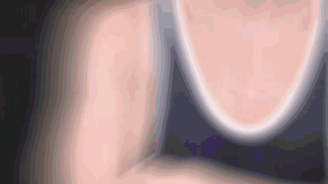 a close up of a person 's arm with a reflection of a person in the mirror .