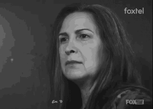 a black and white photo of a woman 's face with a foxtel logo in the corner .