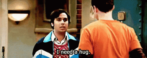 two men are standing next to each other and one of them is saying `` i need a hug . ''
