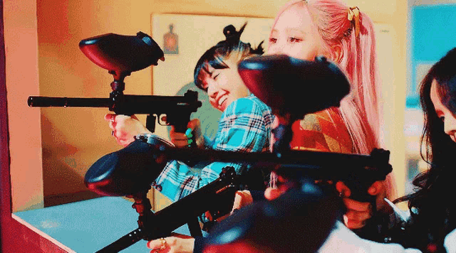 a girl with pink hair is holding a paintball gun in her hand