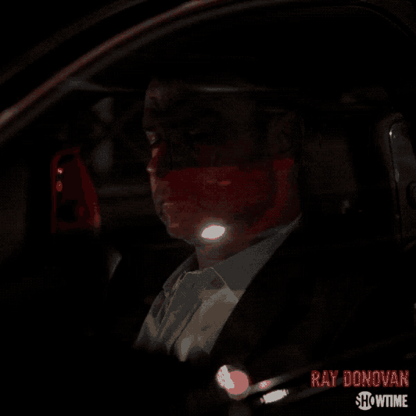 a poster for ray donovan showtime shows a man in a car at night