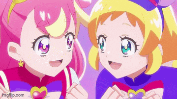 a couple of anime girls are standing next to each other .