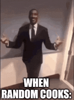 a man in a suit and tie is standing with his arms outstretched in a hallway .