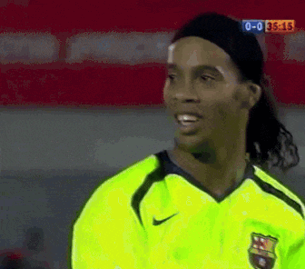 a soccer player wearing a neon green nike jersey stands in front of a scoreboard that reads 0-0 35:15