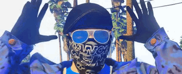 a man wearing a bandana , sunglasses and a hat is making a funny face .