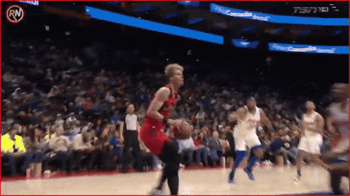 a basketball game is being played in front of a crowd and a sign that says rn
